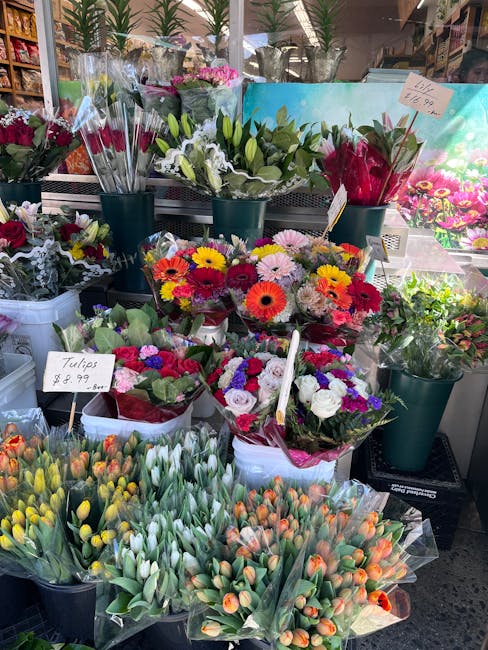 A vibrant display of fresh floral arrangements and bouquets at Brent Cross Flowers, featuring a variety of flowers including tulips, daisies, and roses in an assortment of colors such as yellow, white